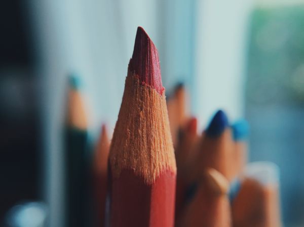 Photo of red pencil tip focused with other colors fuzzy in background